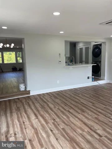 a view of a livingroom with wooden floor and a window