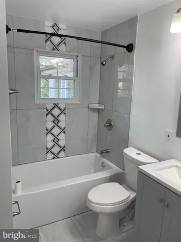 a bathroom with a toilet sink and shower