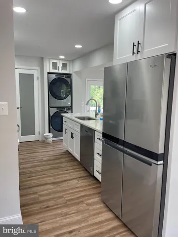 a kitchen with a refrigerator and a stove top oven