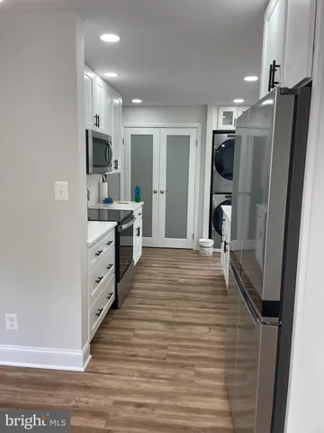 a kitchen with stainless steel appliances a refrigerator sink and microwave