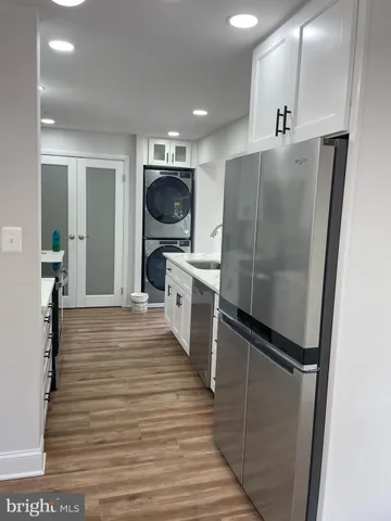 a kitchen with stainless steel appliances a refrigerator and a stove top oven