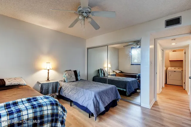a bedroom with two beds and a chandelier
