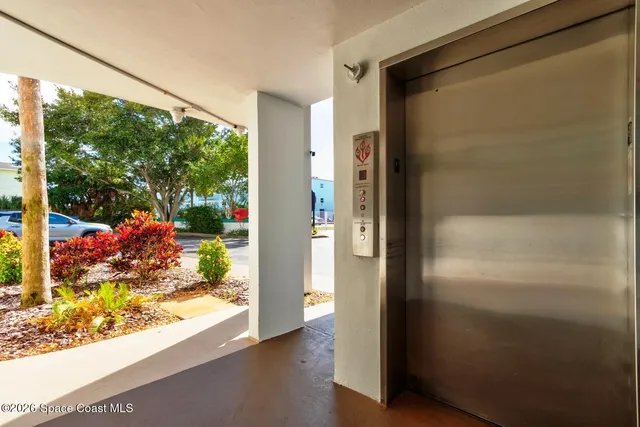 a view of a glass door with a yard from a window