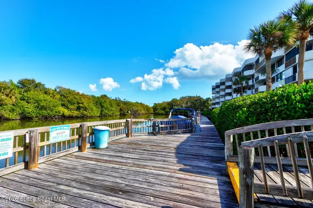 a view of a house with wooden deck