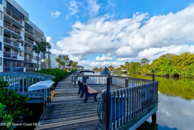 a view of a roof deck with chair and wooden floor