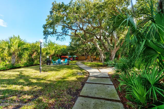a view of a backyard with swimming pool