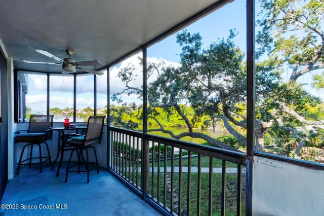 a view of a porch with furniture and wooden floor