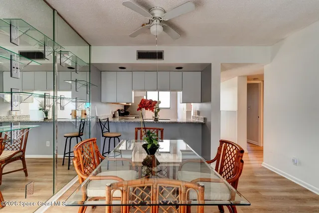 a dining room with furniture a rug and wooden floor