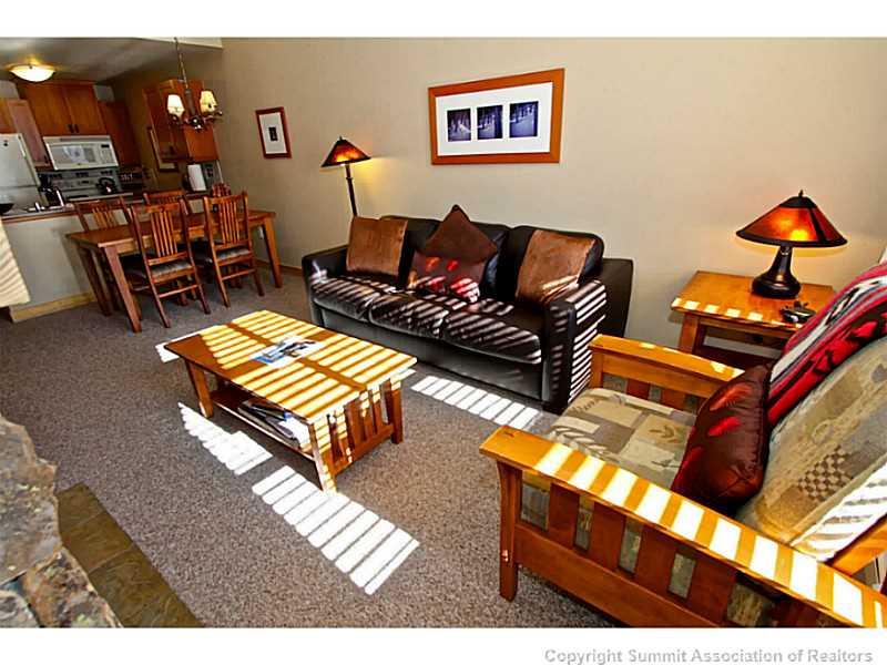 910 Copper Road, Unit 407 Copper Mountain, CO 80443 - Photo 11 of 21 a living room with furniture a rug and a lamp