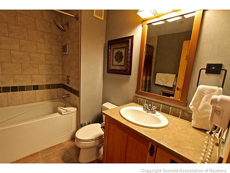 910 Copper Road, Unit 407 Copper Mountain, CO 80443 - Photo 15 of 21 a bathroom with a sink a toilet and shower