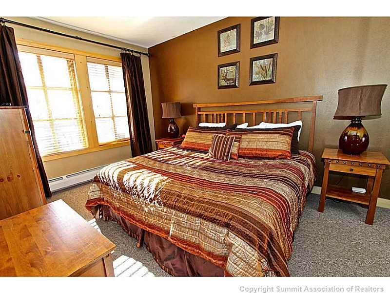 910 Copper Road, Unit 407 Copper Mountain, CO 80443 - Photo 16 of 21 a bedroom with a bed and wooden floor