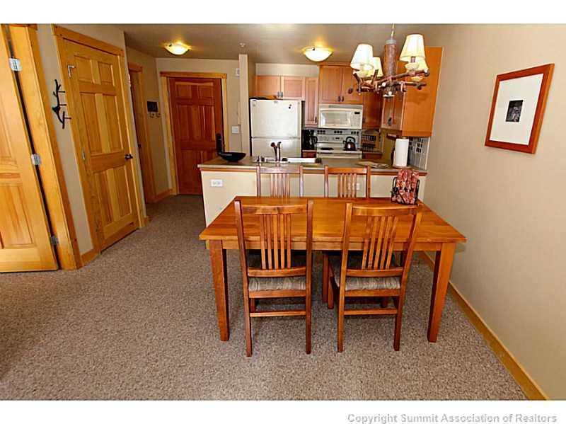 910 Copper Road, Unit 407 Copper Mountain, CO 80443 - Photo 8 of 21 a dining room with furniture and a chandelier