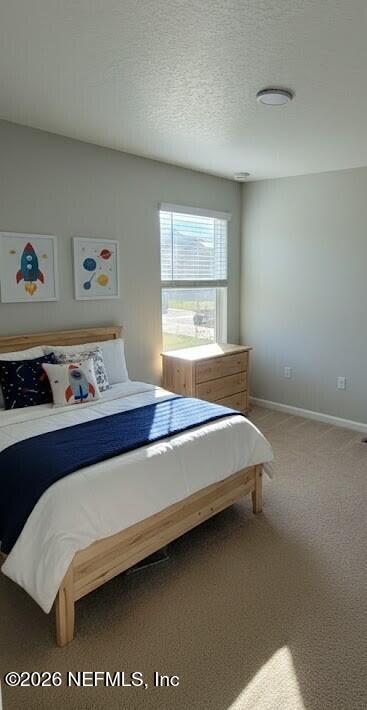 1070 Cahoon Road South Jacksonville, FL 32221 - Photo 5 of 8 a bed sitting in a bedroom next to a window