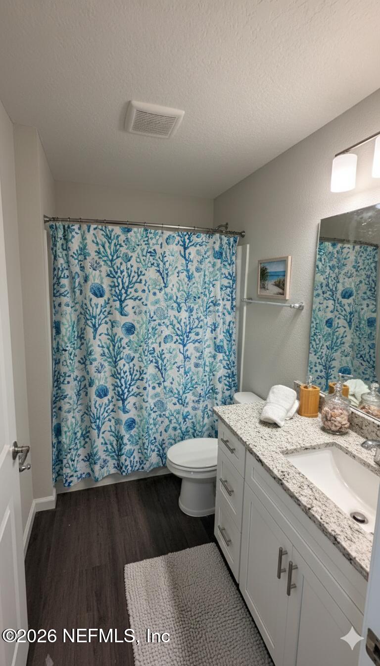 1070 Cahoon Road South Jacksonville, FL 32221 - Photo 7 of 8 a bathroom with a granite countertop sink and a toilet