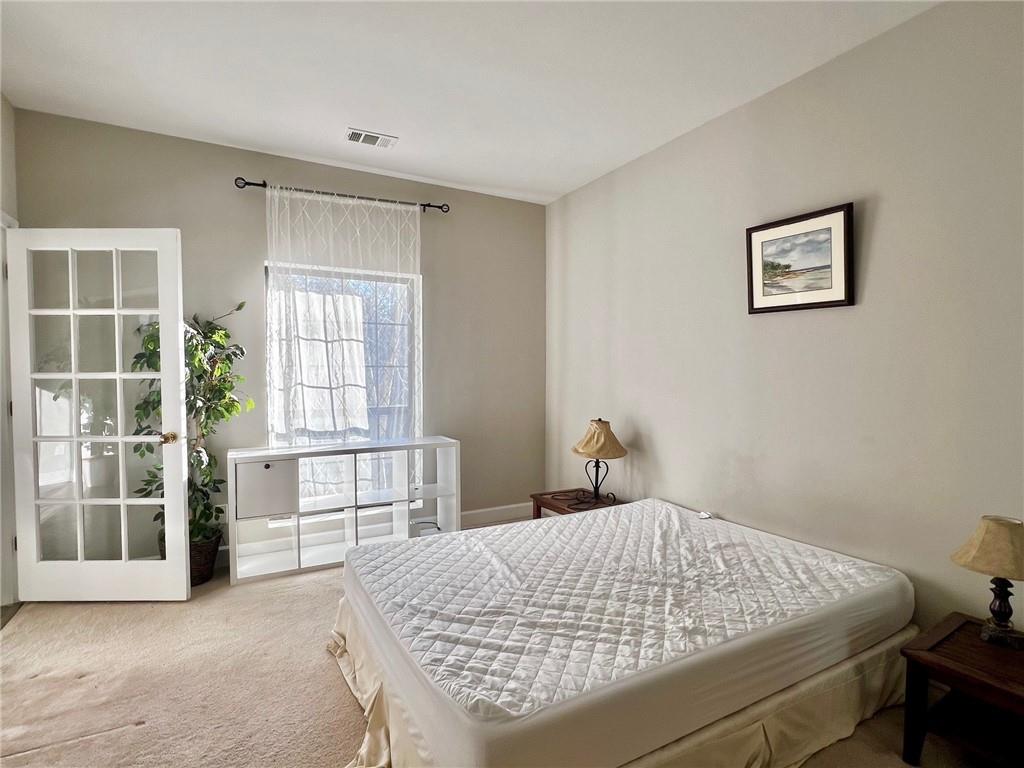 2921 Lenox Road Northeast, Unit 108 Atlanta, GA 30324 - Photo 5 of 9 a bedroom with a bed and a window