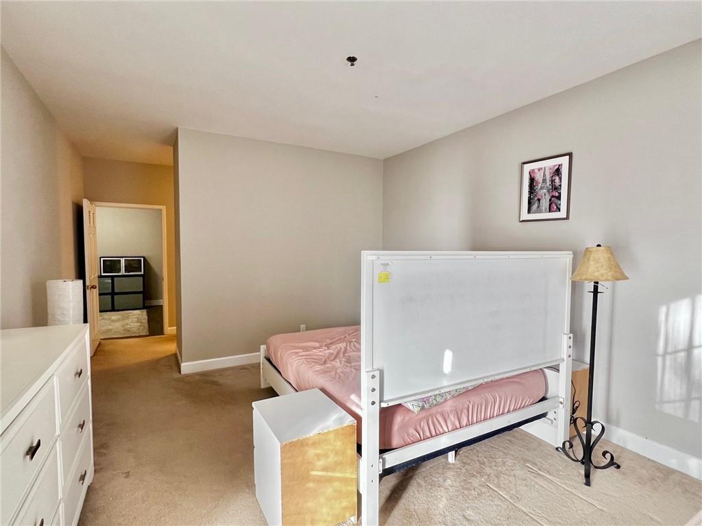 2921 Lenox Road Northeast, Unit 108 Atlanta, GA 30324 - Photo 7 of 9 a living room with furniture and a table