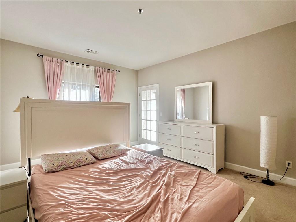 2921 Lenox Road Northeast, Unit 108 Atlanta, GA 30324 - Photo 8 of 9 a bedroom with a bed and a window