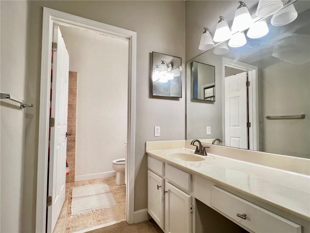 2921 Lenox Road Northeast, Unit 108 Atlanta, GA 30324 - Photo 9 of 9 a bathroom with a sink a light fixture and a mirror