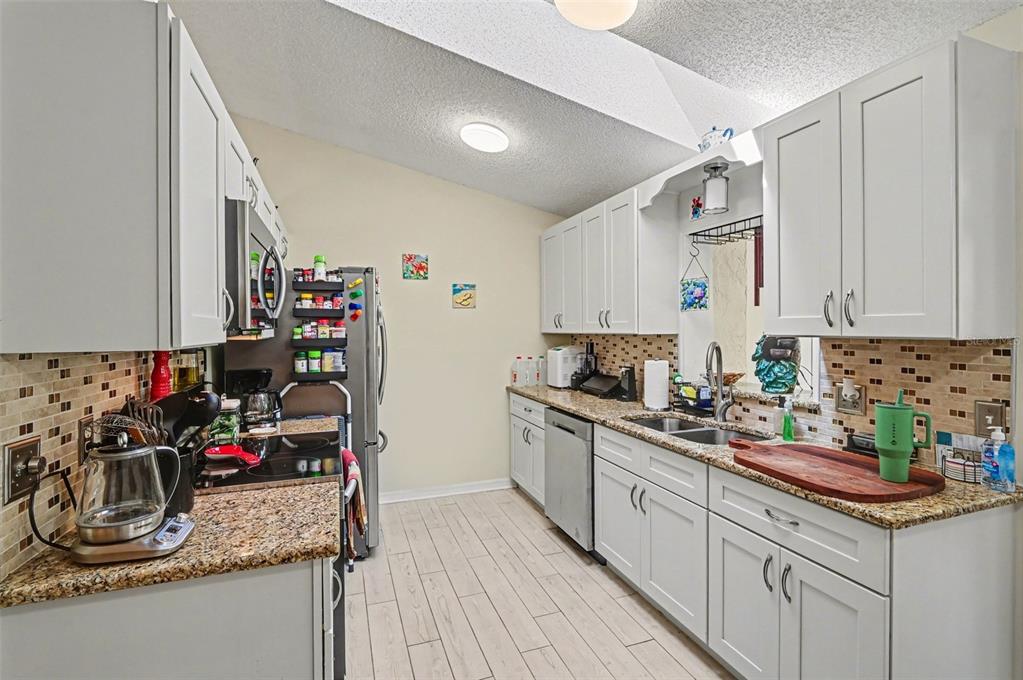 12435 Orangewood Circle Tavares, FL 32778 - Photo 12 of 30 a kitchen with a sink stove and cabinets