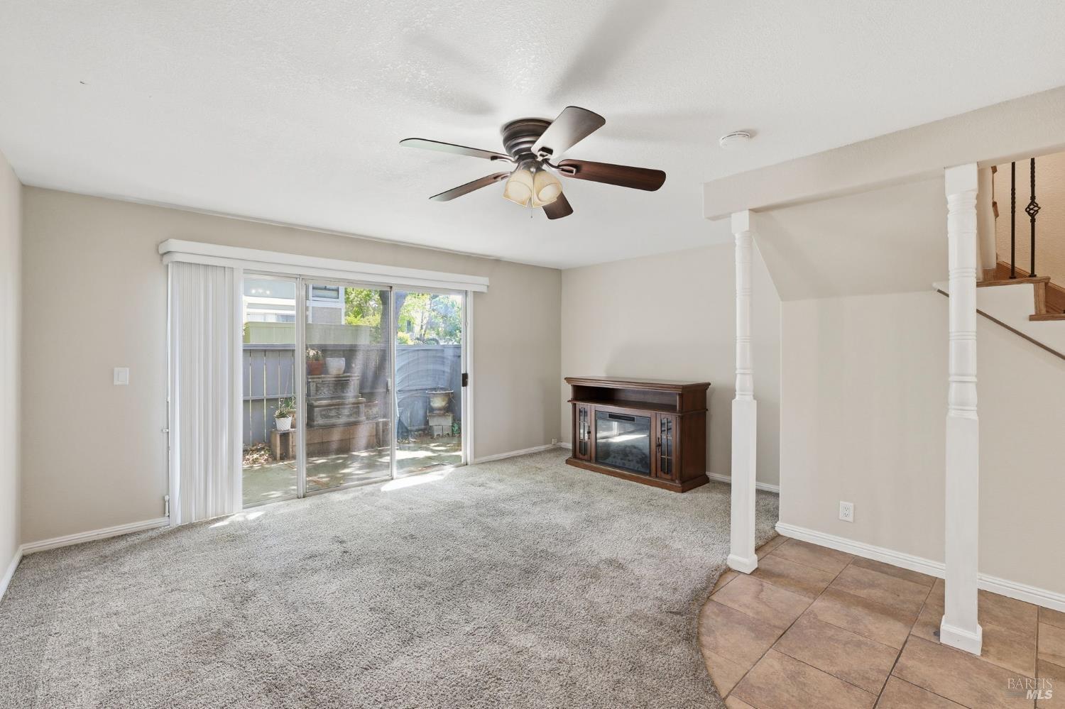 900 Southampton Road, Unit 169 Benicia, CA 94510 - Photo 8 of 21 a view of a livingroom with a ceiling fan a ceiling fan and windows