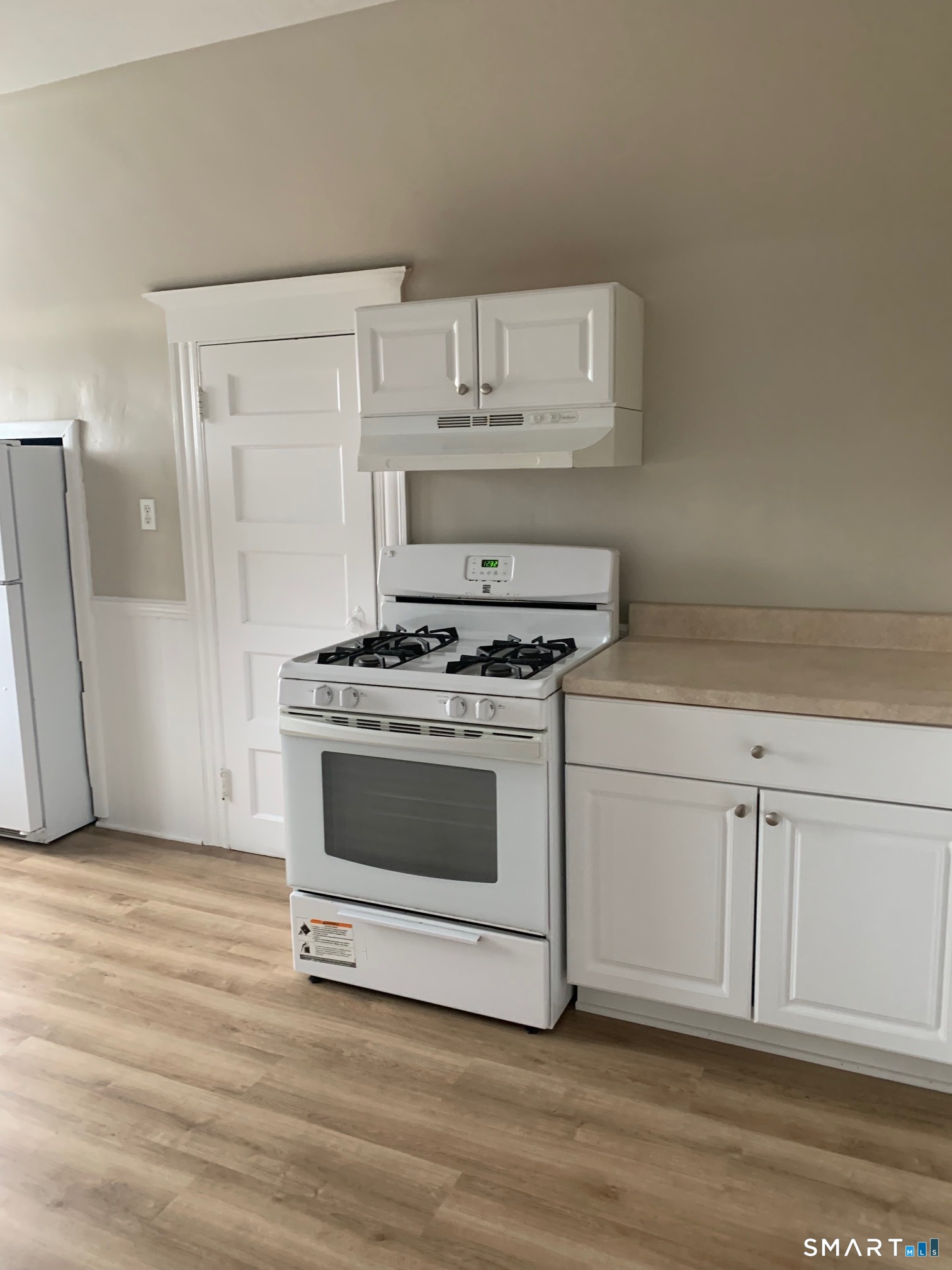 885 Grand Street Bridgeport, CT 06604 - Photo 33 of 40 a kitchen with granite countertop white cabinets and white appliances