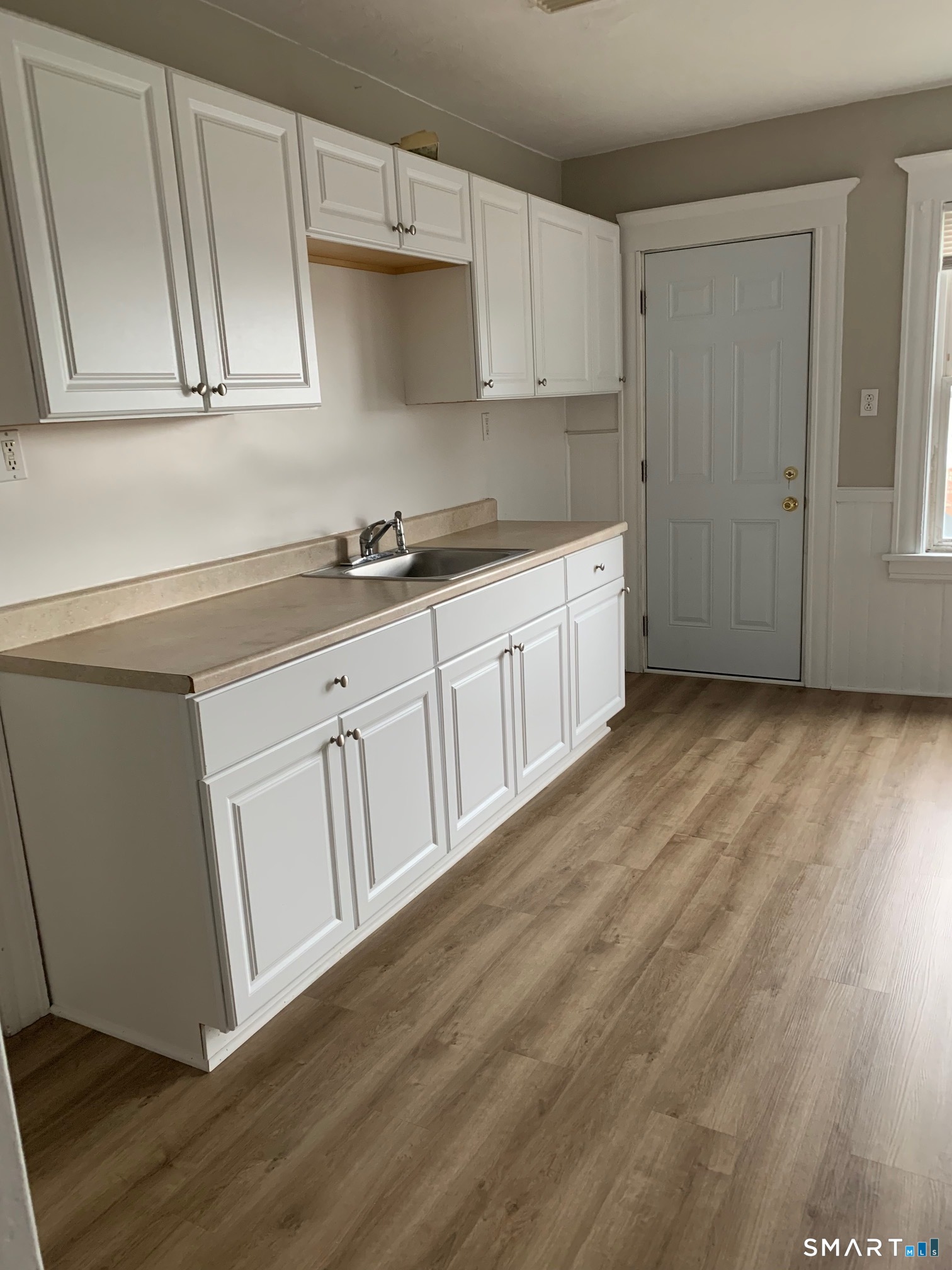885 Grand Street Bridgeport, CT 06604 - Photo 34 of 40 a kitchen with granite countertop white cabinets and sink
