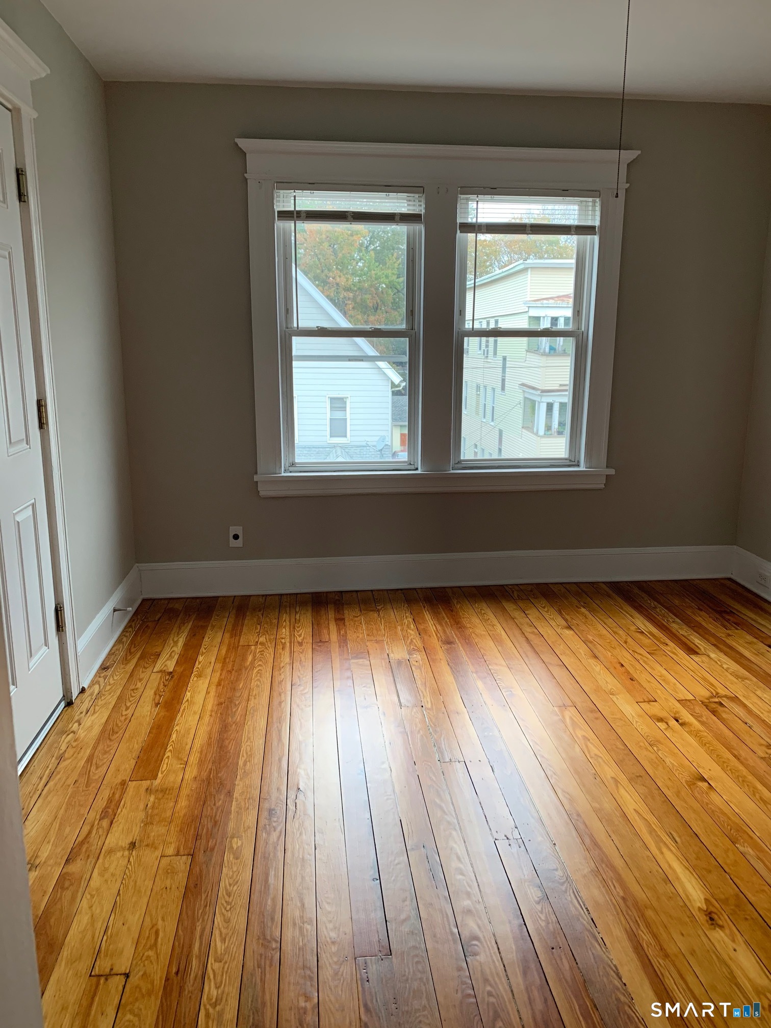 885 Grand Street Bridgeport, CT 06604 - Photo 35 of 40 an empty room with wooden floor and windows