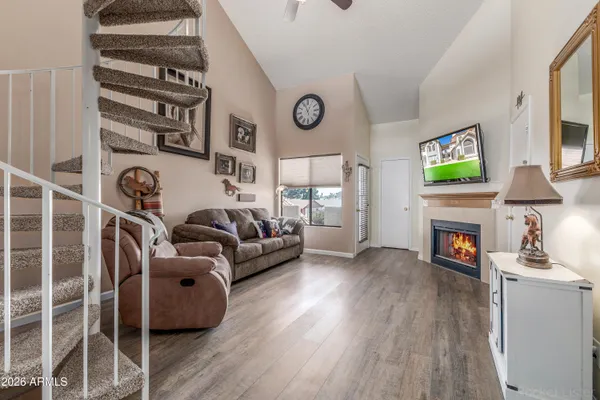 a living room with furniture a fireplace and a flat screen tv