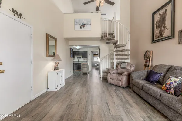 a living room with furniture and wooden floor