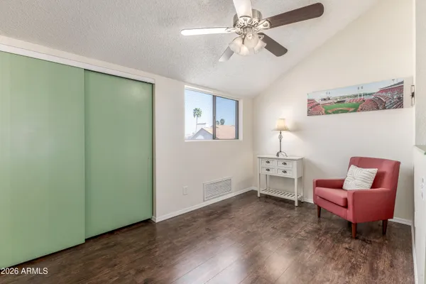 a view of an empty room with a chandelier fan