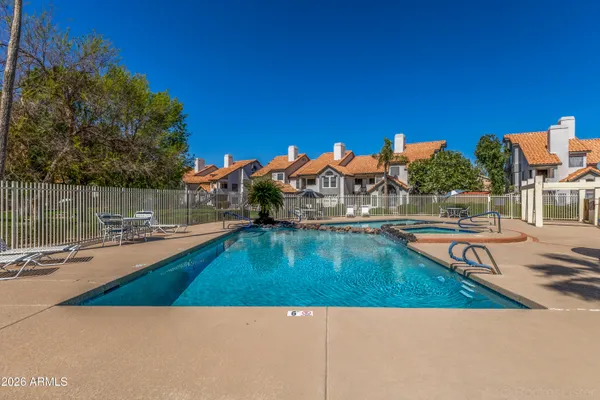 a view of a swimming pool with a table and chairs
