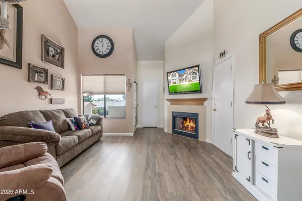 a living room with furniture a fireplace and a flat screen tv