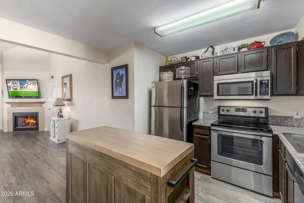 a kitchen with stainless steel appliances a stove a refrigerator and a refrigerator
