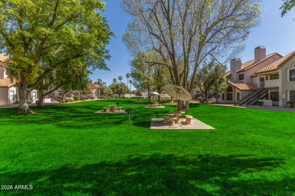 a front view of a house with a yard and trees