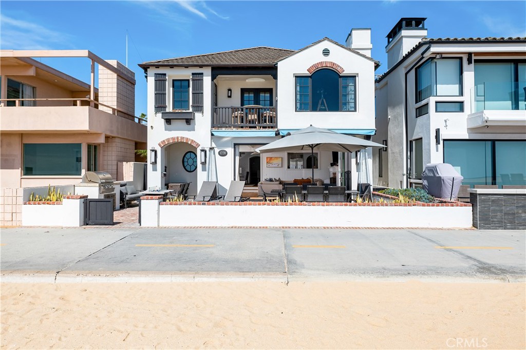 1228 West Oceanfront Newport Beach, CA 92661 - Photo 1 of 32 a front view of a building with street