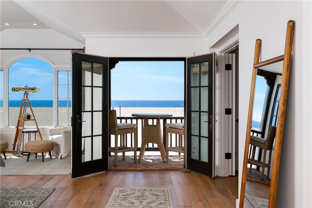 1228 West Oceanfront Newport Beach, CA 92661 - Photo 14 of 32 a view of a hallway with wooden floor and windows