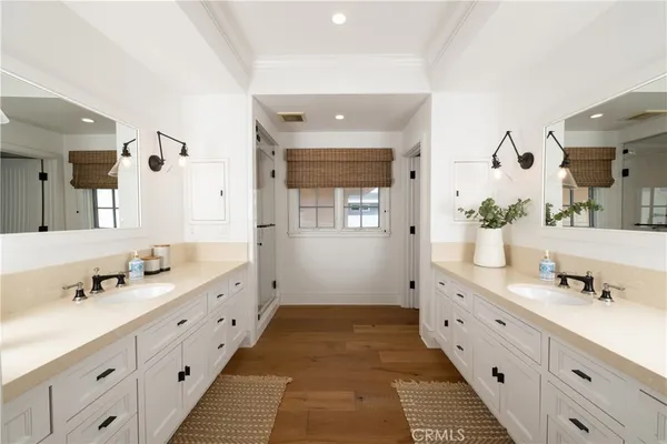 a spacious bathroom with double vanity and mirrors