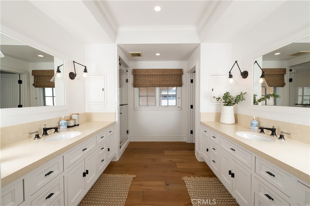 1228 West Oceanfront Newport Beach, CA 92661 - Photo 19 of 32 a spacious bathroom with double vanity and mirrors