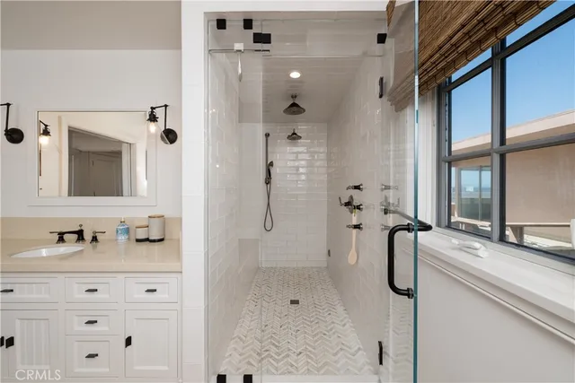 a bathroom with a double vanity sink mirror and shower