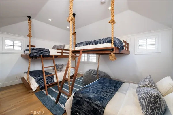 a bedroom with furniture and a wooden floor