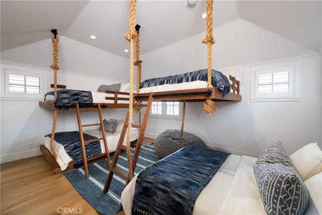 a bedroom with furniture and a wooden floor