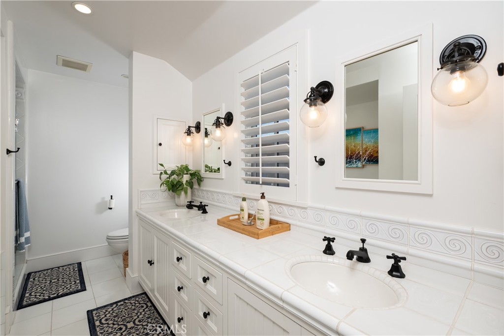 1228 West Oceanfront Newport Beach, CA 92661 - Photo 27 of 32 a bathroom with a sink and a mirror