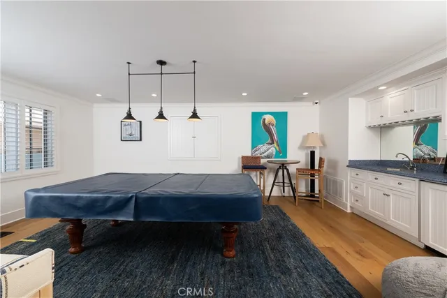 a living room with furniture a table and kitchen view