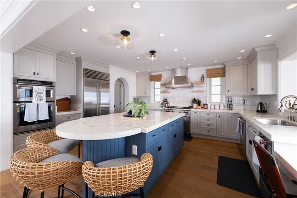 a large kitchen with kitchen island a sink counter space and stainless steel appliances