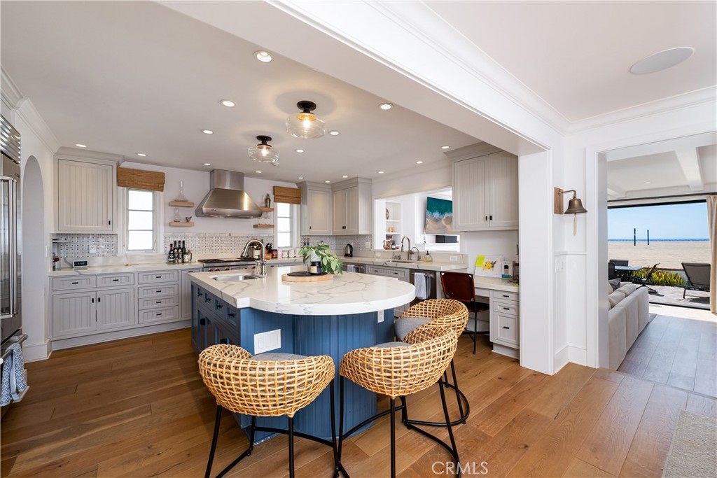 1228 West Oceanfront Newport Beach, CA 92661 - Photo 5 of 32 a kitchen with a dining table chairs and wooden floor