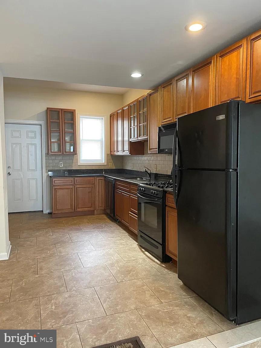 621 North 35th Street Philadelphia, PA 19104 - Photo 4 of 10 a kitchen with stainless steel appliances granite countertop a refrigerator and a sink