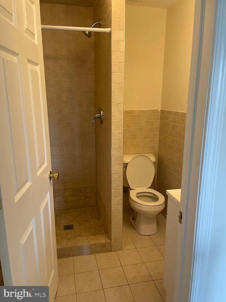 621 North 35th Street Philadelphia, PA 19104 - Photo 6 of 10 a bathroom with a granite countertop toilet and a shower