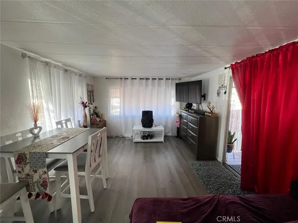 a living room with furniture a dining table and chairs