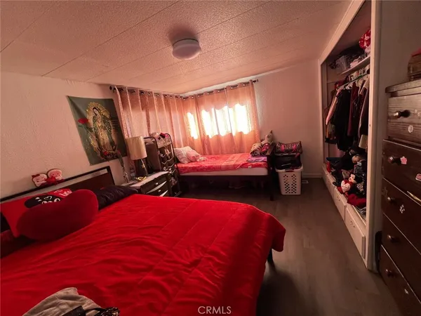 a bedroom with bed and a window