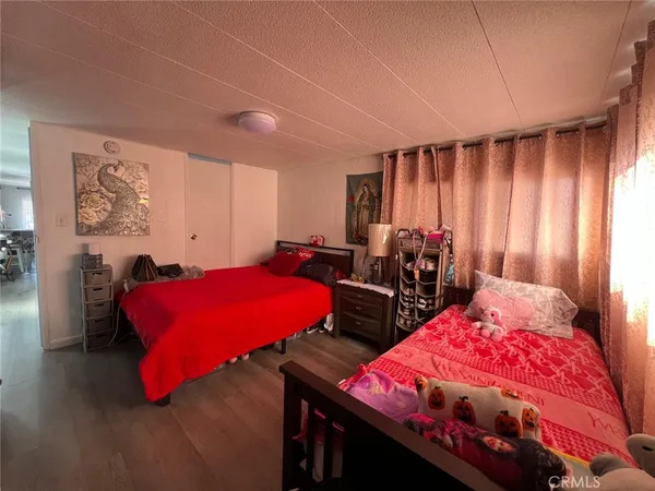 a bedroom with bed and a night stand